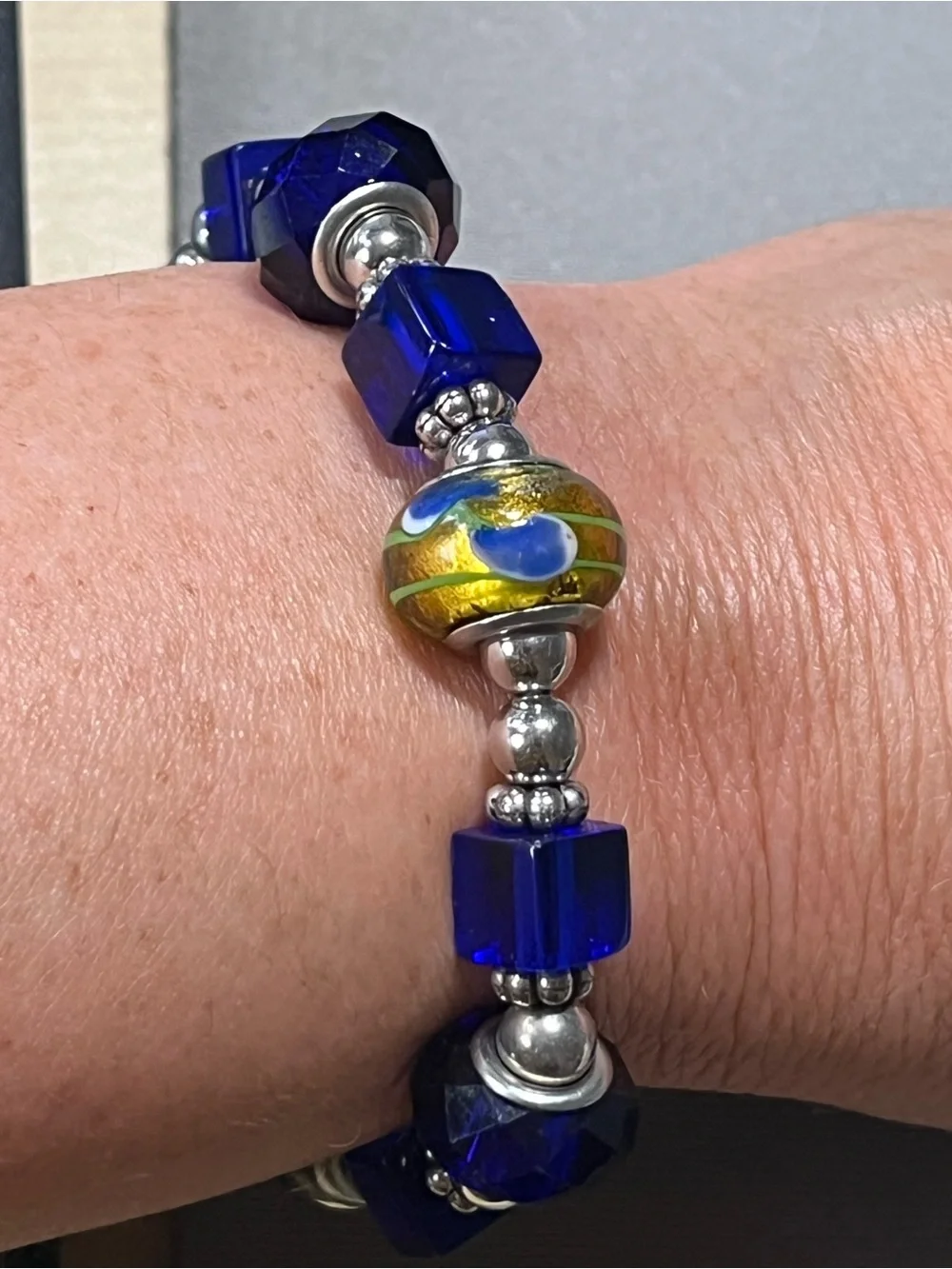 NWOT beautiful blue and yellow plastic beads with silver tone beads in between.
